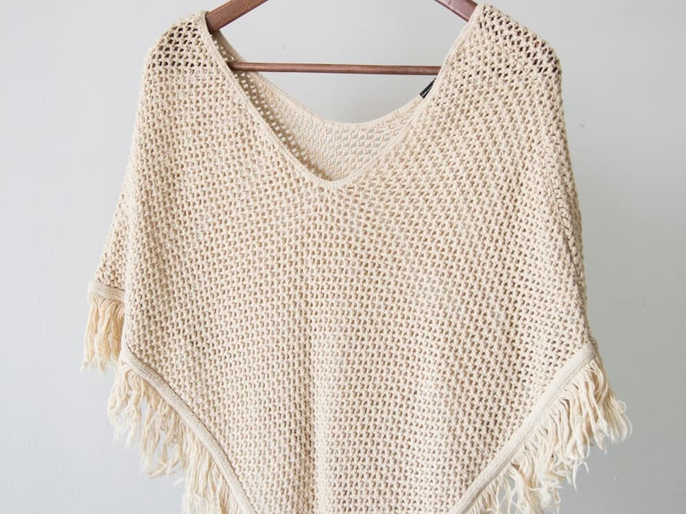A hand-knit sweater on a hanger